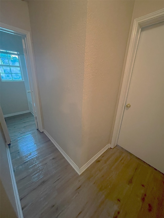 corridor with light hardwood / wood-style flooring