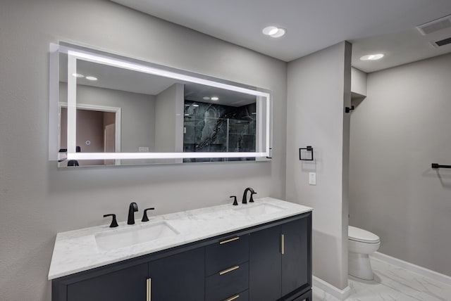 bathroom featuring vanity, toilet, and an enclosed shower