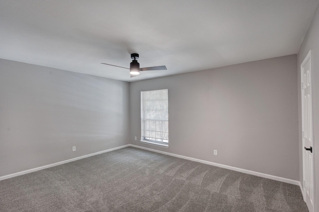 spare room with carpet flooring, baseboards, and ceiling fan