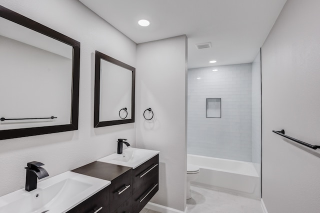 full bathroom featuring tiled shower / bath combo, vanity, and toilet