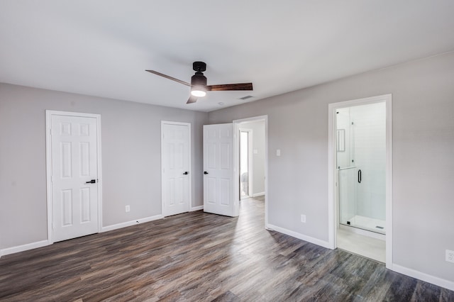 unfurnished bedroom with ceiling fan, ensuite bath, and dark hardwood / wood-style flooring