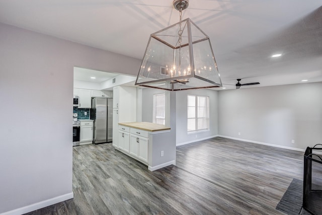 kitchen featuring white cabinetry, a ceiling fan, appliances with stainless steel finishes, and wood counters