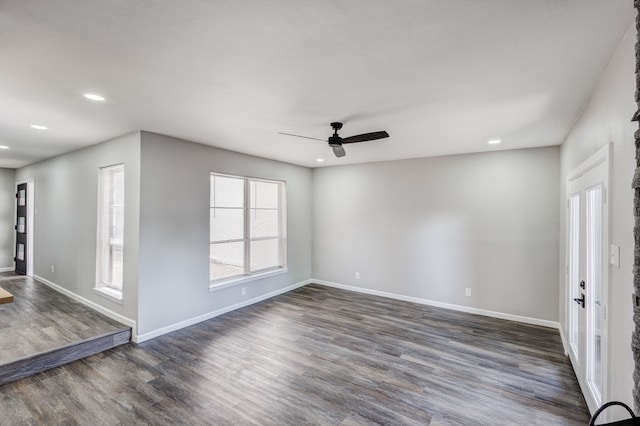 spare room featuring ceiling fan and dark hardwood / wood-style floors