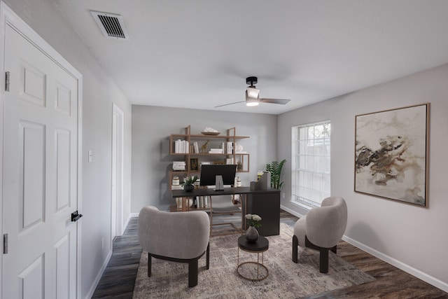 home office with ceiling fan and dark hardwood / wood-style flooring