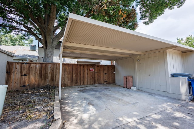 view of parking featuring a carport and fence