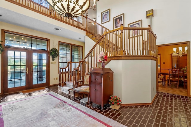 entrance foyer with a high ceiling and french doors