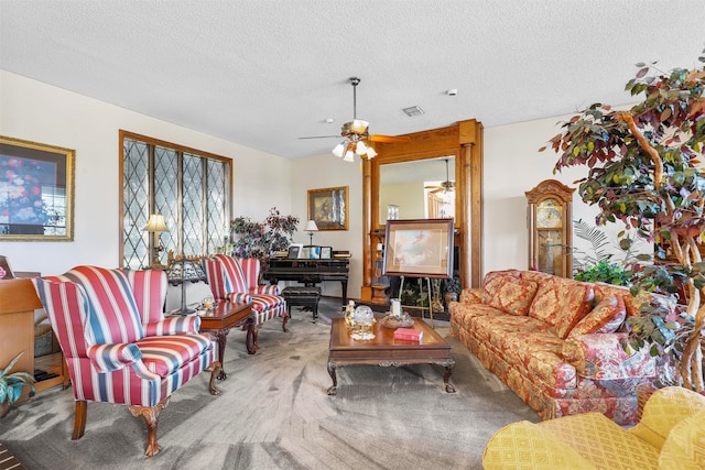 carpeted living room with ceiling fan and a textured ceiling