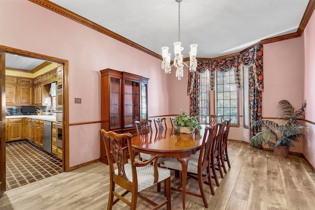 dining space with an inviting chandelier, light wood-type flooring, and crown molding