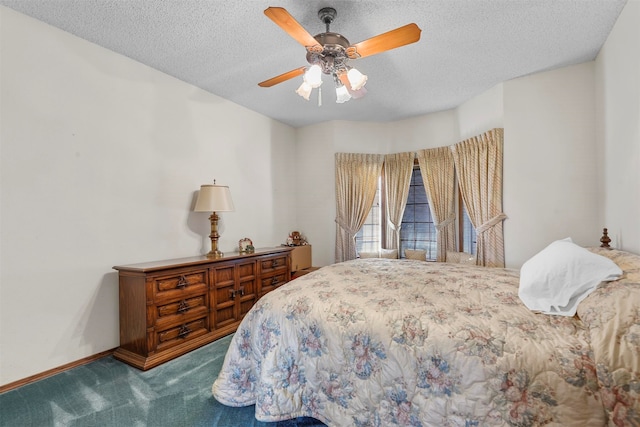 carpeted bedroom with ceiling fan and a textured ceiling