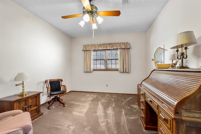 sitting room with ceiling fan, carpet flooring, and a textured ceiling