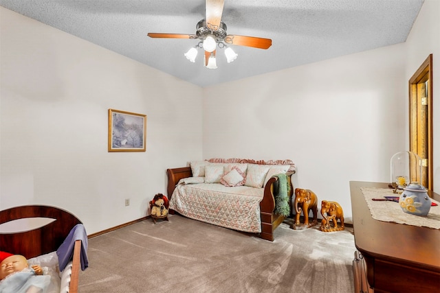 bedroom with carpet floors, a textured ceiling, and ceiling fan