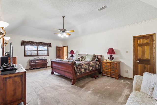 carpeted bedroom with vaulted ceiling, ceiling fan, and a textured ceiling