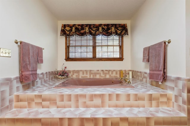 bathroom with a textured ceiling and a washtub