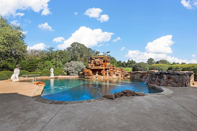 view of swimming pool with a patio and pool water feature