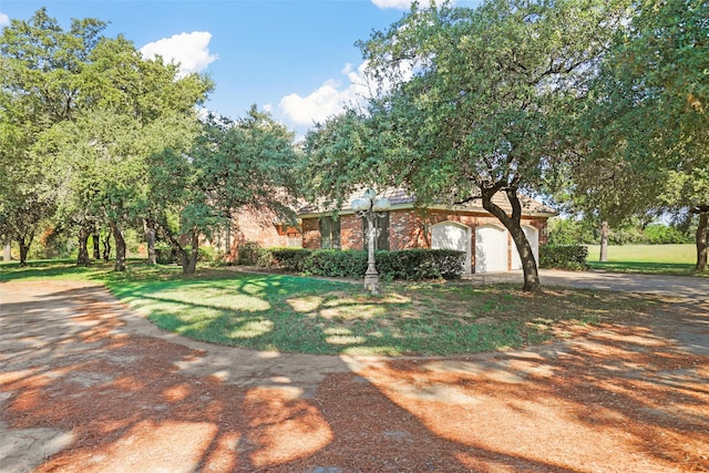 view of front of house with a front yard and a garage