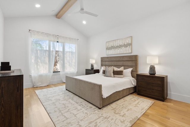 bedroom featuring ceiling fan, light hardwood / wood-style floors, and lofted ceiling with beams