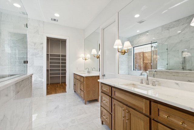 bathroom with vanity and a shower with shower door