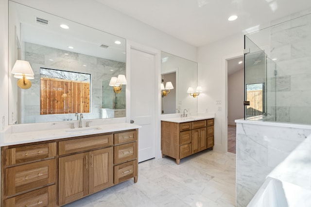 bathroom with vanity and a shower with door