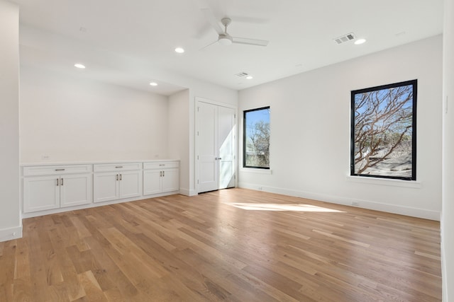 spare room with light hardwood / wood-style floors and ceiling fan