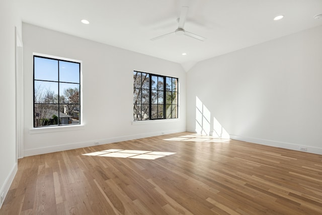 spare room featuring a wealth of natural light, light wood-type flooring, and ceiling fan