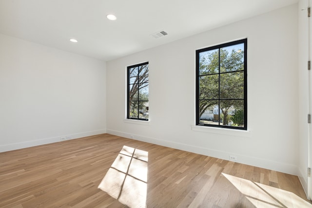 empty room with light hardwood / wood-style flooring