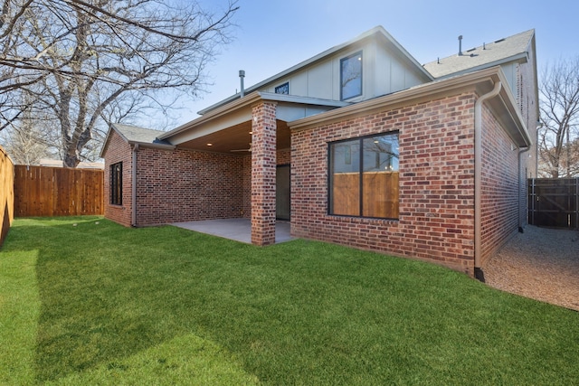 rear view of property featuring a lawn and a patio