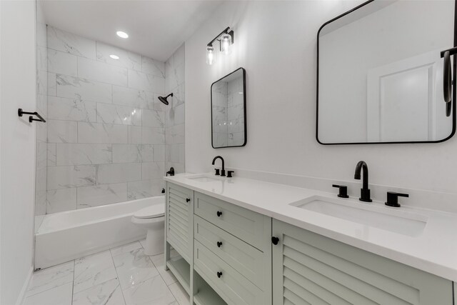 full bathroom with tiled shower / bath, vanity, and toilet