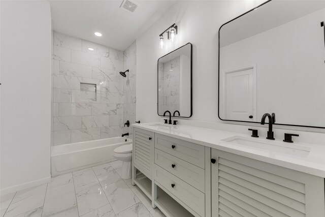 full bathroom featuring tiled shower / bath combo, vanity, and toilet