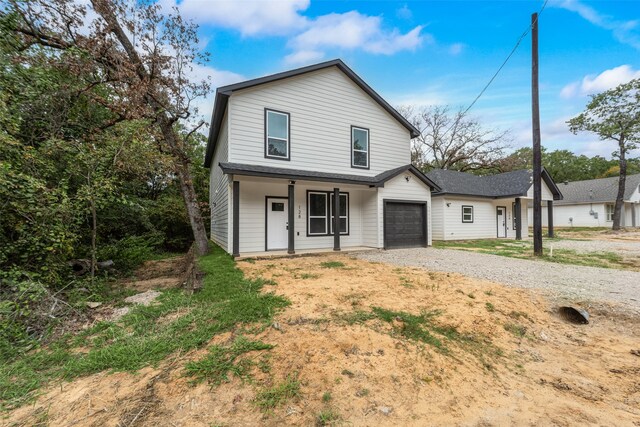 view of front property featuring a garage and a porch