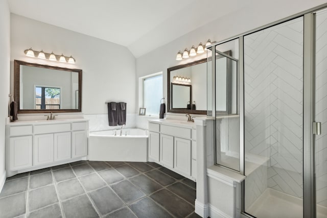 bathroom with vanity, shower with separate bathtub, tile patterned flooring, and vaulted ceiling