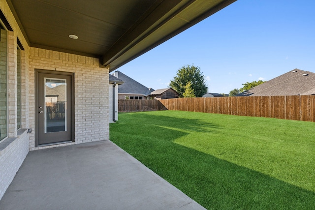 view of yard featuring a patio area and a fenced backyard