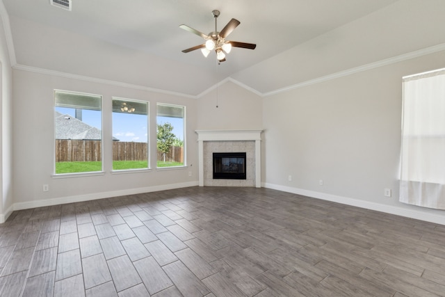 unfurnished living room featuring vaulted ceiling, a fireplace, ceiling fan, light hardwood / wood-style flooring, and ornamental molding