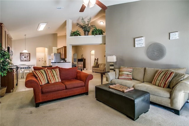 living room with light carpet, lofted ceiling, and ceiling fan