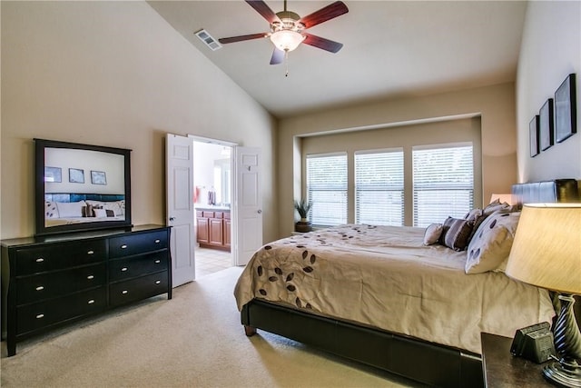 bedroom featuring ceiling fan, light colored carpet, ensuite bath, and high vaulted ceiling