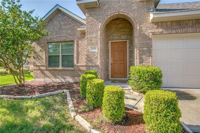 view of exterior entry featuring a garage