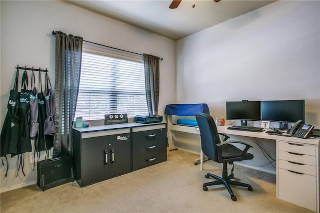 carpeted office space featuring ceiling fan