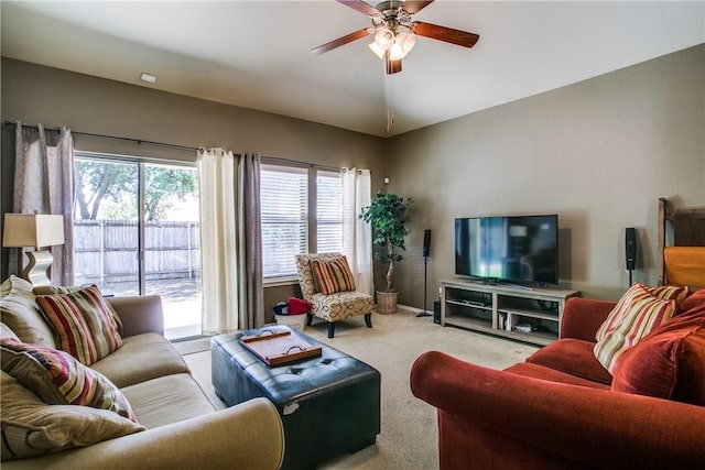 living room featuring light carpet, lofted ceiling, and ceiling fan