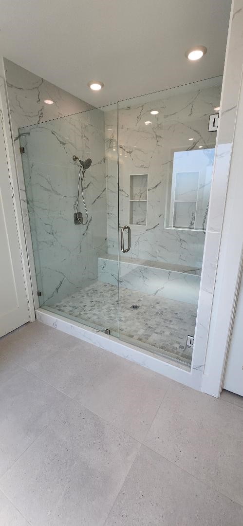 bathroom featuring a shower with shower door