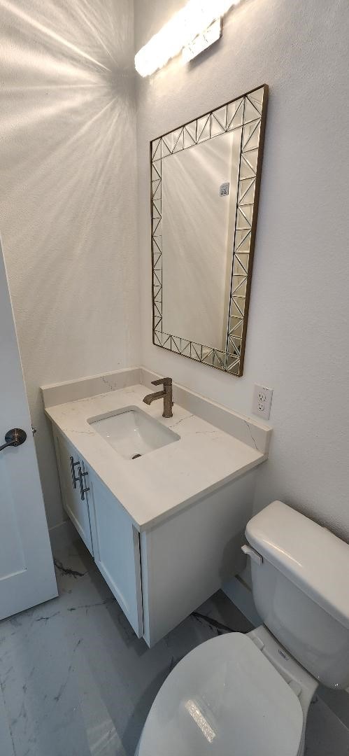 3338 Sylvan Ave, Dallas, TX 75212 - bathroom featuring vanity and marble look tile flooring