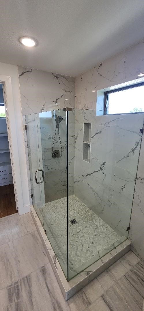 bathroom featuring a shower with shower door