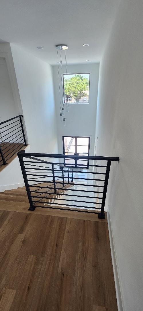 stairs featuring hardwood / wood-style flooring