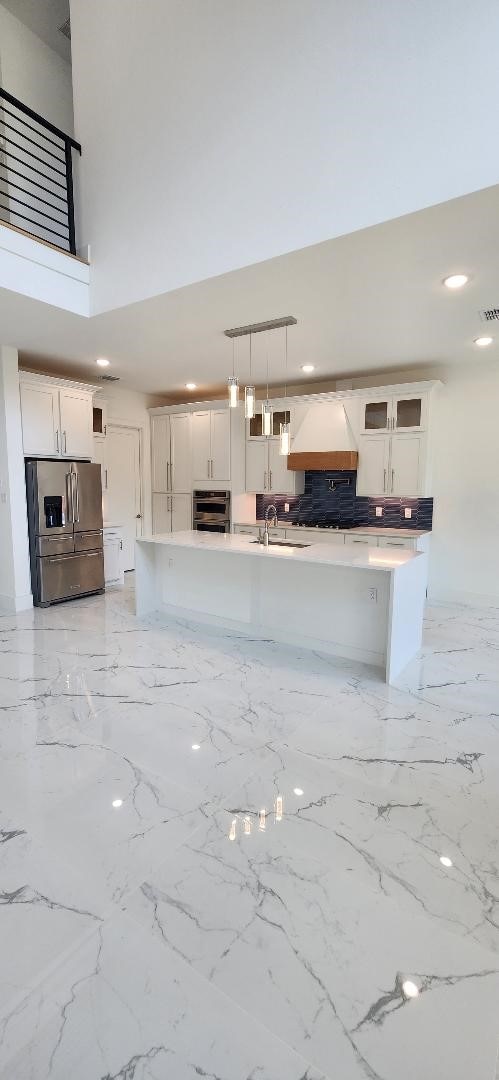 3338 Sylvan Ave, Dallas, TX 75212 - kitchen featuring stainless steel appliances, premium range hood, white cabinets, hanging light fixtures, and recessed lighting