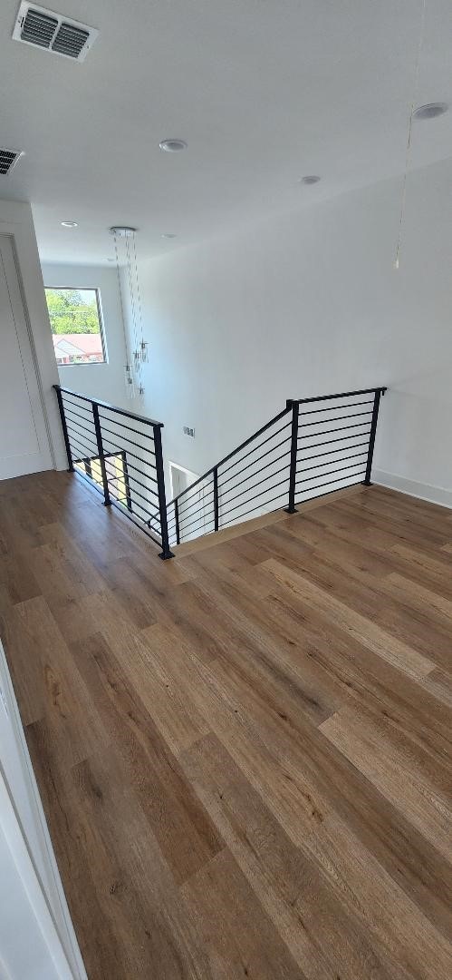 stairs featuring hardwood / wood-style floors