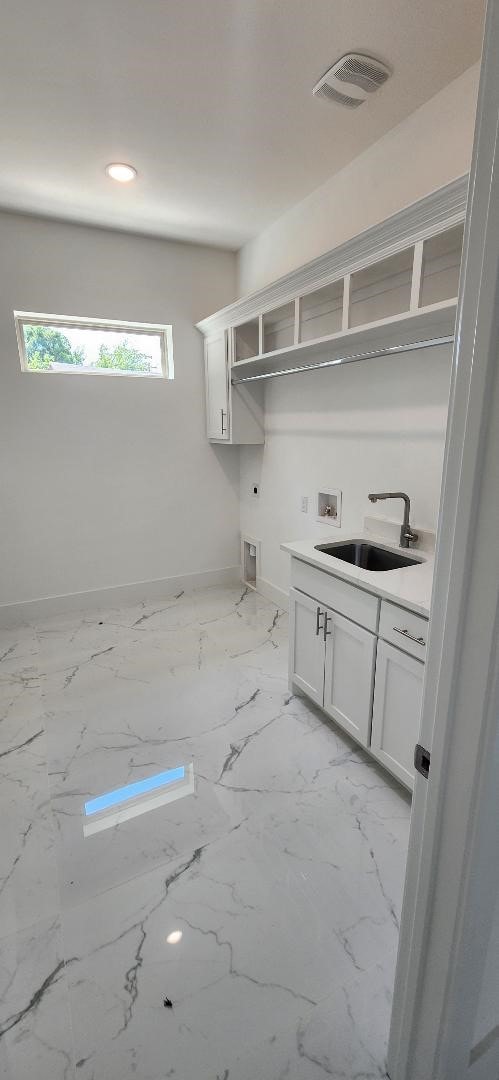 3338 Sylvan Ave, Dallas, TX 75212 - washroom with washer hookup, electric dryer hookup, cabinet space, light marble finish flooring, and recessed lighting