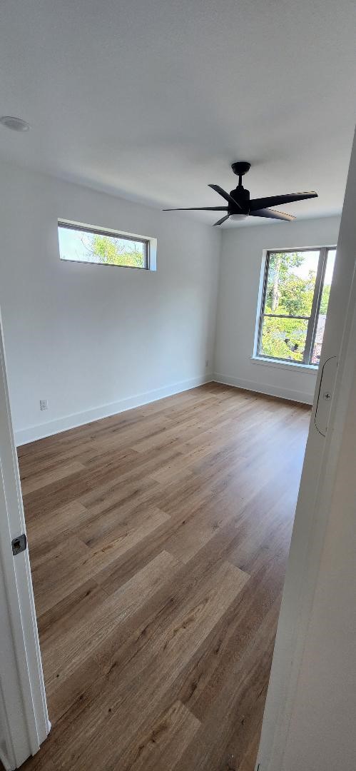 spare room with ceiling fan and hardwood / wood-style flooring