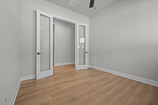 unfurnished bedroom with light hardwood / wood-style flooring, a closet, ceiling fan, and french doors