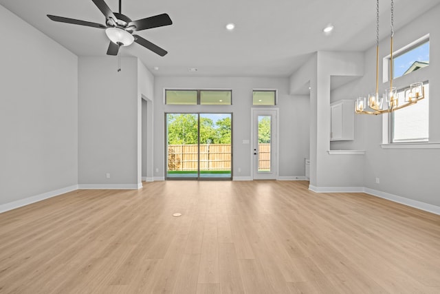 unfurnished living room with ceiling fan and light wood-type flooring