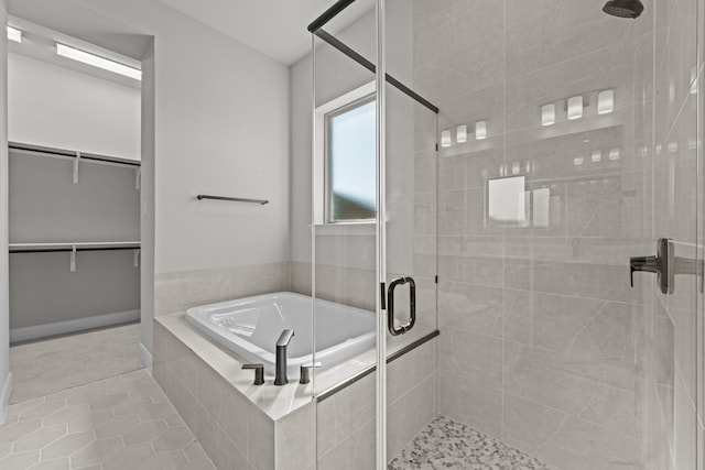 bathroom with independent shower and bath and tile patterned floors