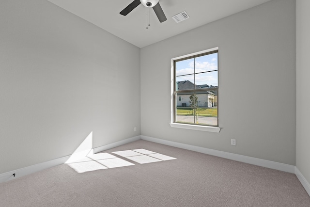 carpeted spare room featuring ceiling fan