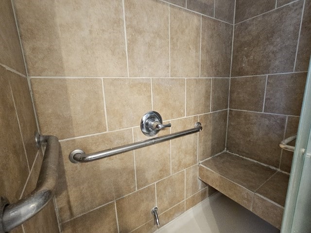 bathroom with a tile shower